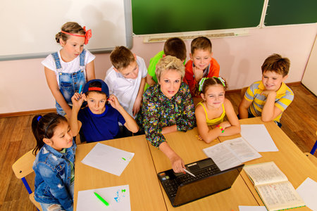 Favorite teacher. Portrait of students with their teacher during the lesson. Educational concept.
