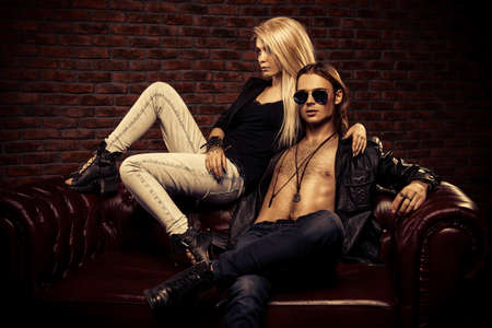 Passionate young woman with her brutal sexual man in a luxurious apartments. Love concept. Rock musicians.の写真素材