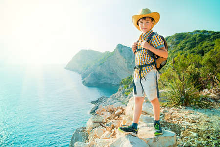 Happy boy spends the summer holidays at the seaside. Outdoor activities, tourism and adventure.の写真素材