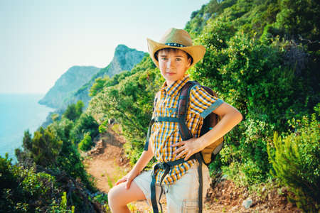 Happy boy spends the summer holidays at the seaside. Outdoor activities, tourism and adventure.の写真素材