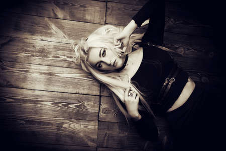 Young woman with long blonde hair and black smokey eyes. Beauty, fashion. Black make-up. Gothic style.の写真素材