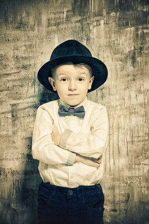 Portrait of a cute little boy in elegant clothes. Be like daddy. Kid's fashion.