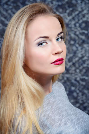 Fashion shot of an attractive young woman with blonde hair and evening make-up.の写真素材