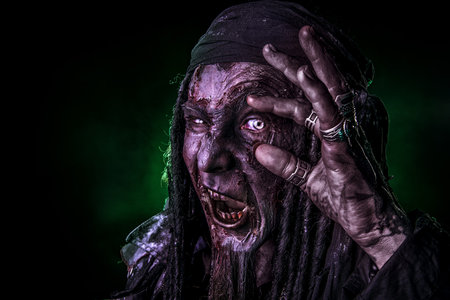Fantasy pirate, risen from the dead. Pirate zombie in hell green light. Halloween.