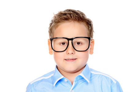 Portrait of a big confident smart boy wearing classic shirt and glasses. Isolated over white...