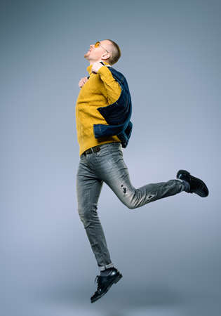 Full length portrait of a handsome male model posing in a motion.の写真素材