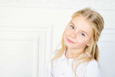 Beautiful little girl in white dress.の写真素材