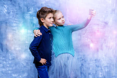 Modern children are making selfie. Children's fashion. Modern lifestyle.の写真素材