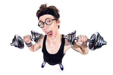 Funny thin man doing exercises with dumbbells. Bodybuilding, muscle building. Sports, activities concept. Isolated over white.の写真素材