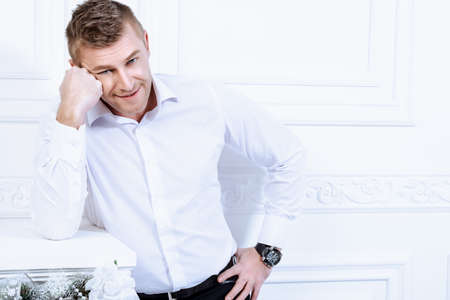 Business concept. Men's beauty, fashion. Handsome mature man wearing classic white shirt.の写真素材