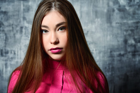 Portrait of a beautiful young woman with long brown hair. Make-up, cosmetics. Hair, healthy hair....