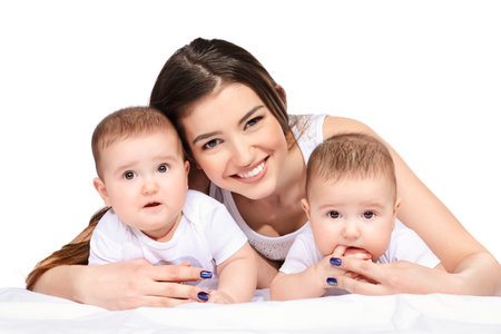 Beautiful happy mother playing with her baby children. Family concept. Healthy children. Isolated...