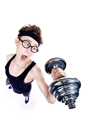 Funny thin man doing exercises with dumbbells. Bodybuilding, muscle building. Sports, activities concept. Isolated over white.の写真素材