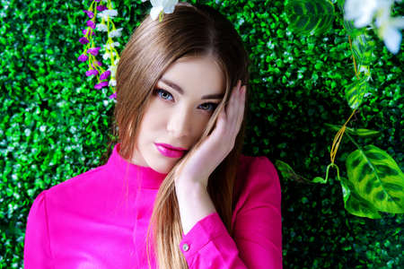 Spring girl portrait. Beautiful young woman in the lush garden. Beauty, fashion concept. Cosmetics and perfumery.の写真素材