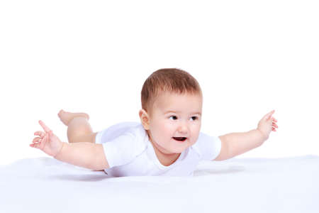 Cute little baby lying on the blanket and smiling. Baby healthcare. Family concept. Isolated over white.の写真素材