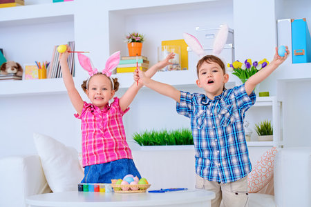 Two happy funny children preparing for the celebration of Easter.