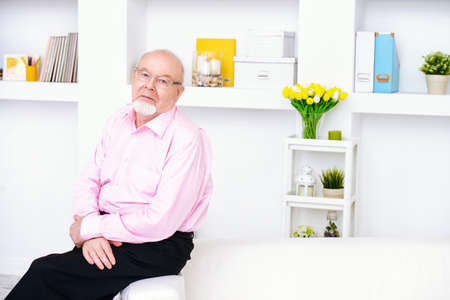 Happy smiling old man having a rest at home. Retirement.の写真素材