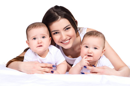 Beautiful happy mother playing with her baby children. Family concept. Healthy children. Isolated...