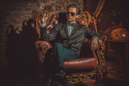 Imposing well dressed man in a classic luxurious apartments. Luxury. Men's beauty, fashion.の写真素材