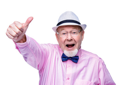 Joyful excited old man showing thumb. Happiness. Success and victory concept. Isolated over white.の写真素材