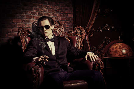 Imposing well dressed man in a classic luxurious apartments. Luxury. Men's beauty, fashion.の写真素材