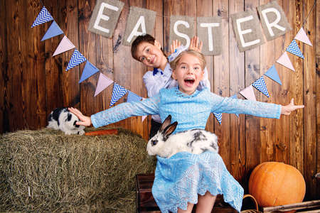 Easter holidays. Happy children posing with Easter Bunny and painted eggs in Easter decorations.の写真素材