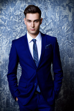 Fashion shot of a handsome young man in elegant classic suit. Men's beauty, fashion.の写真素材
