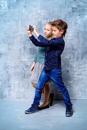 Modern children are making selfie. Children's fashion. Modern lifestyle.の写真素材