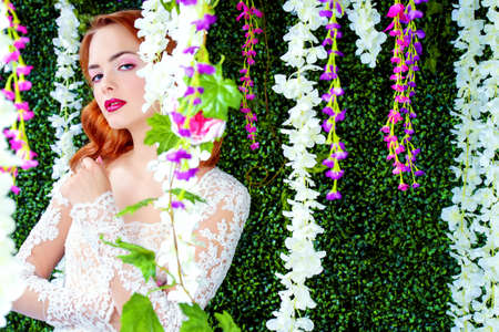 Portrait of a charming young woman in the flowered garden. Spring Fantasy. Beautiful bride girl portrait. Fashion shot.の写真素材