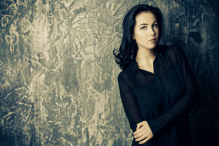 Portrait of a beautiful young woman with brunette hair. Beauty, fashion concept. Cosmetics.の写真素材