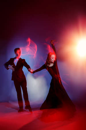 Art concept. Beautiful vigorous dancers performing tango at studio.の写真素材