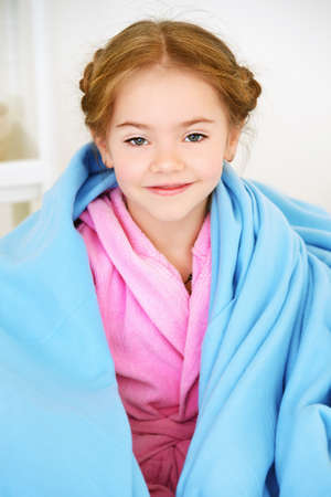 Happy smiling child girl having a rest at home. Happy childhood.の写真素材