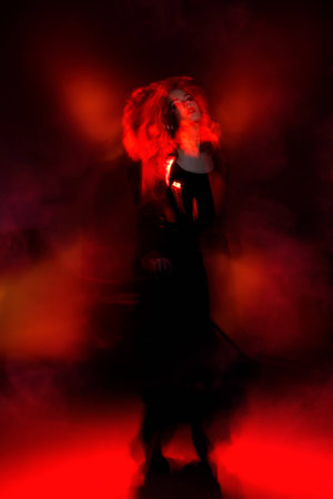 Art concept. Beautiful young woman dancer performing tango at studio.