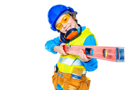 Portrait of a boy in a helmet playing builder with tools. Different occupations. Isolated over white background.の写真素材