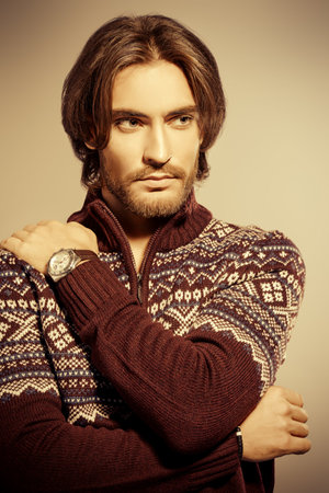 Handsome man wearing winter pullover. Men's beauty, fashion. Hairstyle for men. Studio shot. Sepia style.の写真素材