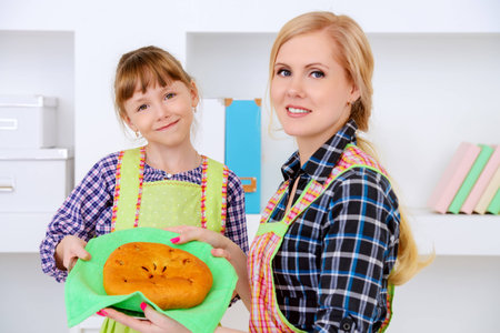 Loving family concept. Happy mother cooks with her daughter.の写真素材