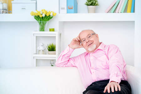 Happy smiling old man having a rest at home. Retirement.の写真素材