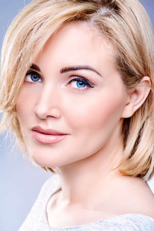 Close-up portrait of a beautiful well-groomed middle-aged woman. Skincare, rejuvenation, cosmetics.の写真素材