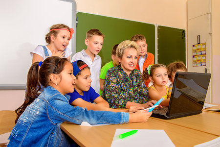 Portrait of students with their teacher during the lesson.