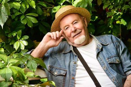 Portrait of a handsome senior man having a rest on a sunny summer day. Healthcare, resort. Happy retirement.の写真素材