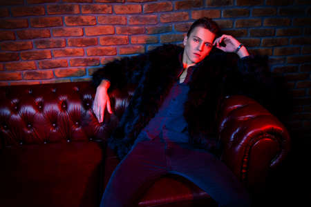 Handsome young man spending time at night club or casino. Entertainment industry. Beauty, fashion concept.の写真素材