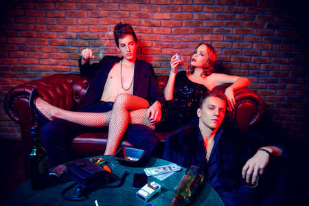 Modern young people spending time at night club or casino. Entertainment industry. Beauty, fashion concept.の写真素材