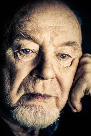 Portrait of old man over black background. Old age concept.の写真素材