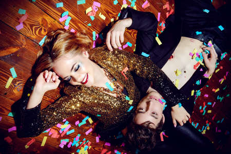 After party. Group of cheerful young people relaxing after night party.の写真素材