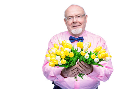 Happy smiling old man gives a bouquet of tulips flowers. Women's Day, 8 of March, birthday concept....