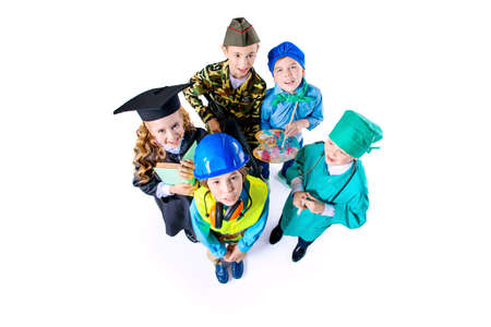 Different professions. A group of children dressed in costumes of different professions. Isolated over white.の写真素材