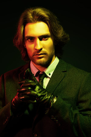 Respectable well-groomed man in an expensive suit and black leather gloves. Male beauty, fashion....