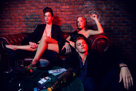 Modern young people spending time at night club or casino. Entertainment industry. Beauty, fashion concept.の写真素材