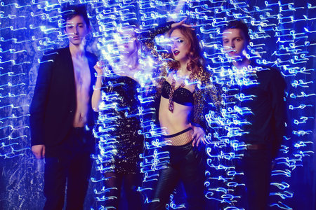 Group of cheerful young people dancing at a night party.の写真素材