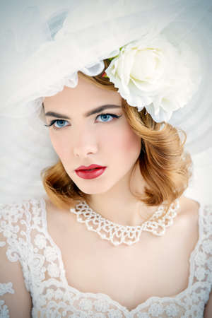 Portrait of a beautiful tender bride woman wearing elegant lace dress and broad-brimmed hat. Wedding. Beauty, fashion concept.の写真素材
